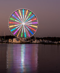Illuminated ferris wheel at National Harbor near the nation capital of Washington DC at sunset
