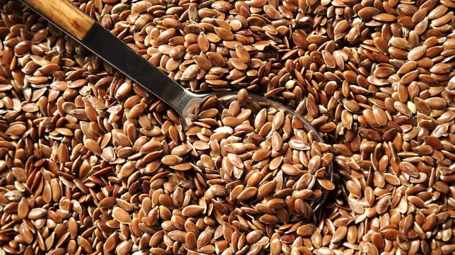 Brown raw flax seeds linseed as natural food background or grain texture. Flaxseeds full of omega 3 fatty acids. Top down view. Healthy diet organic nutrition."