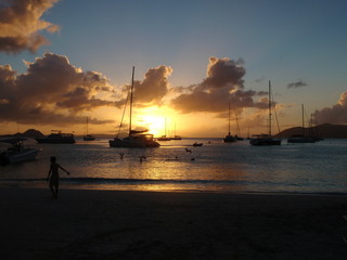 Sun set through yatchs from shore