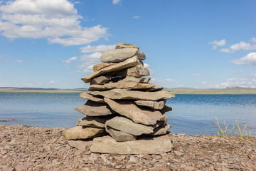 Balance stones pyramid meditation harmony similar with blue lake and sky on background