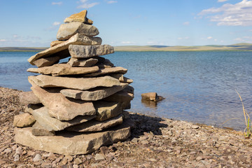 Balance stones pyramid meditation harmony similar with blue lake and sky on background