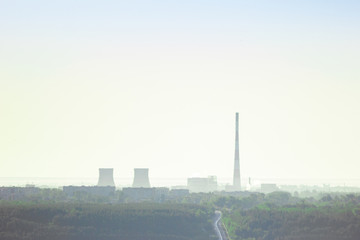 Fototapeta na wymiar The pipes or tubes of thermal power station in the clear sunny day on the horizon