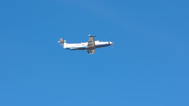 Generic Turboprop Private Airplane Flying in a Blue Sky after Taking Off on a Sunny Day