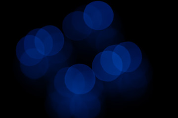 Abstract background. Blue blurry bokeh spots on black background