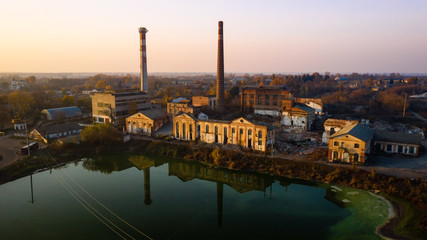 Aerial view of an old factory ruin and broken windows. Old industrial building for demolition.