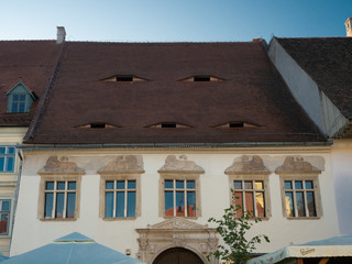 Unique style of old historic buildings in Sibiu, Romania which are eyes on the roof; small attic...