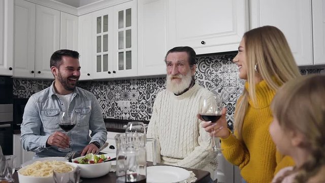 Beautiful portrait of high-spirited pleasant family which gethering together to celebrate Thanksgiving day at the festive table