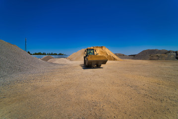 Quarry aggregate with heavy duty machinery. Construction industry. Horizontal