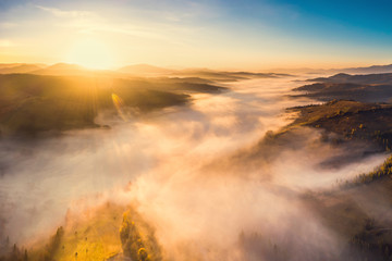 Naklejka na ściany i meble Scenic autumn landscape with fog in mountains