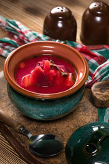 Red borscht soup in bowl.