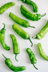 Green peppers isolated on white background. Top view