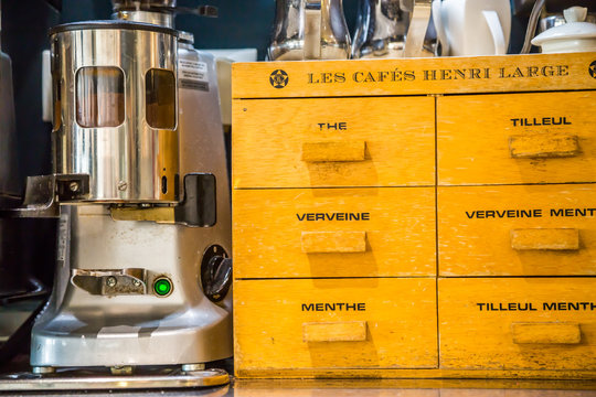 La defense, France - July 17, 2016: closeup on vintage tee box and coffee grinder in a big traditional french restaurant in la defense city, the greatest business center in france near Paris.