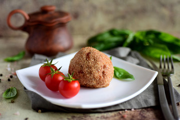 Delicious Scotch eggs on a white plate. A large meatball with an egg on a beautiful plate.