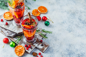 Orange and cranberry drinks with orange slices and spices. Hot drinks for winter and Christmas