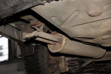 old dirty car muffler, handicraft repair