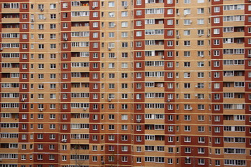Fototapeta na wymiar Wall of a contemporary multi-storey apartment building, texture for the background