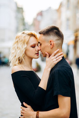 Outdoor hot couple portrait. .Sexy girl kissing with boyfriend on the street