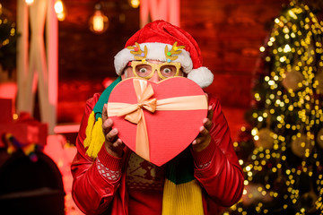 Surprise concept. Man senior Santa claus hold gift box. Winter ideas. Celebrate new year. Kindness and generosity. Giving gift. Delivery service. Gift shop. December sale. Christmas gift. Spread love