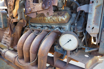 old rusty car engine motor and pressure gauge
