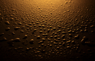 water drops on a plastic brown background in the dark
