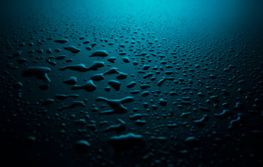 water drops on a plastic blue background in the dark