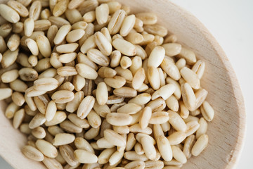 Wheat grain in wooden spoon