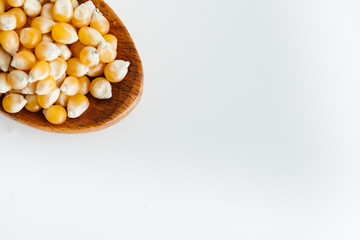 corn grains in wooden spoon