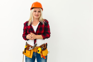 Attractive blonde business woman working as an architect on a building construction site