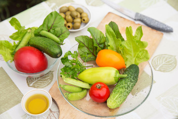 Fresh raw vegetables and greens on plate. Ingredients for cooking vegetarian, diet healthy food	