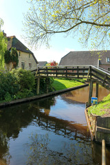 Bridge over the canal in venice of the north - small cosy village Giethoorn in Netherlands