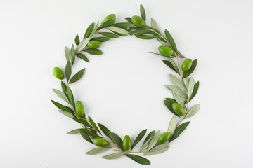 Green olive wreath on white background. Top view