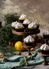 lemon cupcakes with whipped meringue on wooden cake stands 