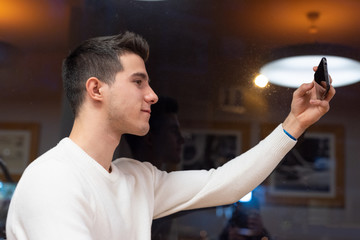 Portrait of Happy young man taking selfie at the coffee shop . 