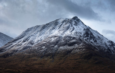 Fototapeta na wymiar Snowcapped mountain peak in Scottish highlands.