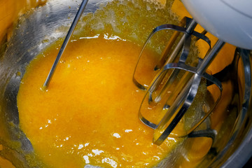 Beating the yolk with a mixer in pan.