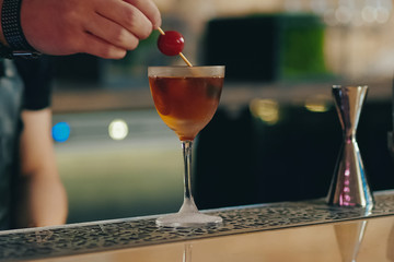Bartender pouring cocktail at bar counter
