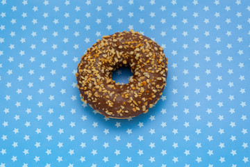 donut on blue with stars background, top view