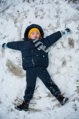 Fototapeta na wymiar The boy lies in the snow