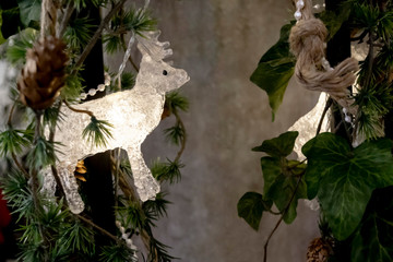 Home on a winter evening. Christmas winter home decoration in natural Scandinavian style. Glowing in the dark Christmas rustic decorations. 