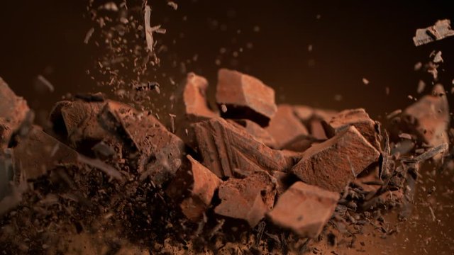 Super slow motion of flying group of raw chocolate pieces. Filmed on high speed cinema camera, 1000fps.