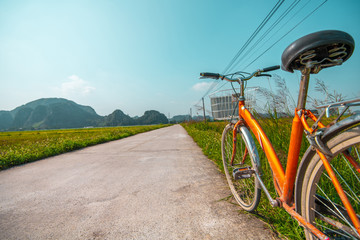 Close up of bike near a rice field in the beautiful countryside of rural Vietnam