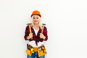 working woman in helmet with tools