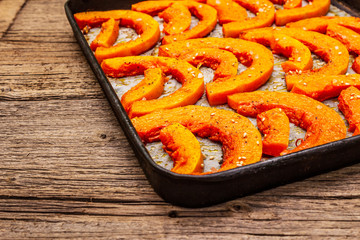 Baked pumpkin with vegetable oil, sesame seeds and spices. Vegan (vegetarian) healthy food concept