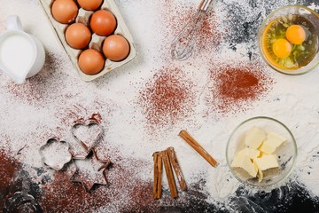Cooking And Baking Ingredients Utensils On White Concrete Background. Kitchen Food Frame. Eggs Sugar Milk Whisker Rolling Pin And Measuring Spoons With Spices