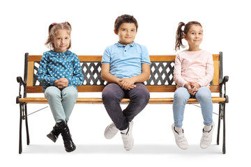 One boy and two girls sitting on a bench