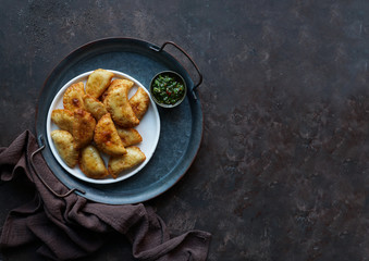 Latin American fried empanadas with  sauce. Top view.