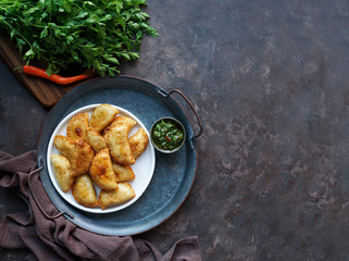 Latin American fried empanadas with  sauce. Top view.
