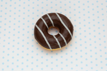 donut on white with gray stars background, top view