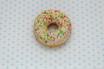 donut on white with gray stars background, top view