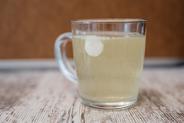 a glass of water in which a cold medicine is dissolved